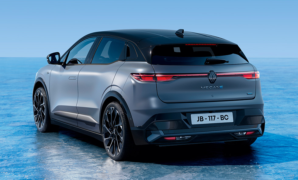Renault Megane E-Tech electric in grey rear three-quarter shot on a blue studio background