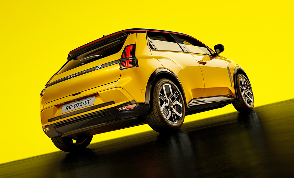 Renault 5 E-Tech electric in yellow rear three-quarter shot on a yellow studio background