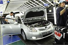 Toyota cuts hours and wages