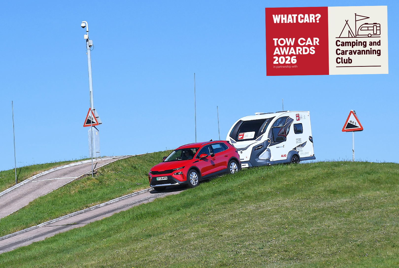 Skoda Elroq descending steep slope while towing caravan
