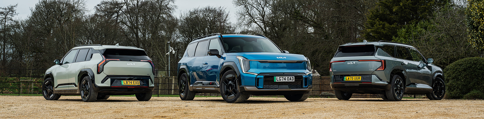 Kia EV3, EV5 and EV9 parked together on gravel
