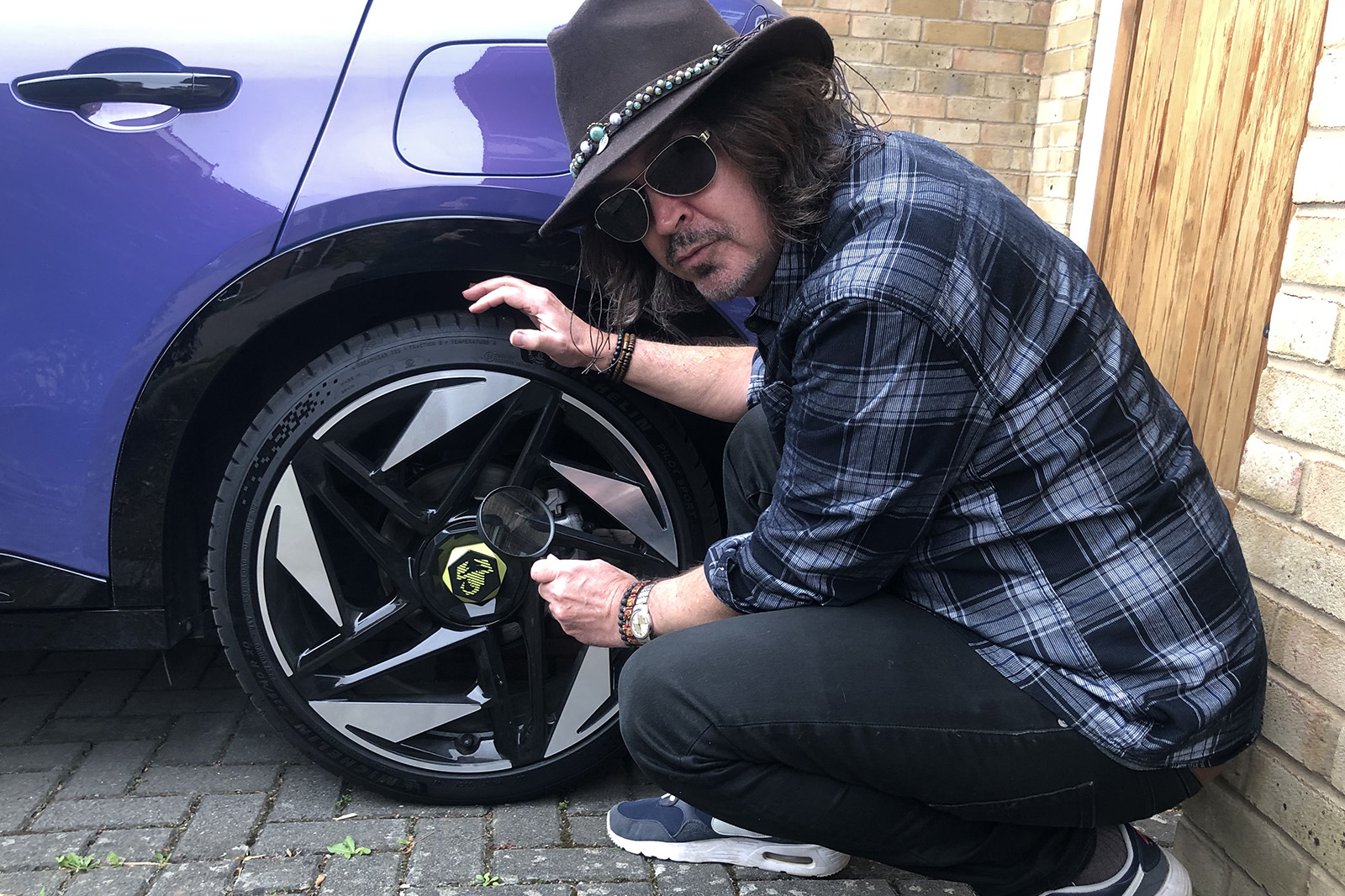Abarth 600e mark examining wheel