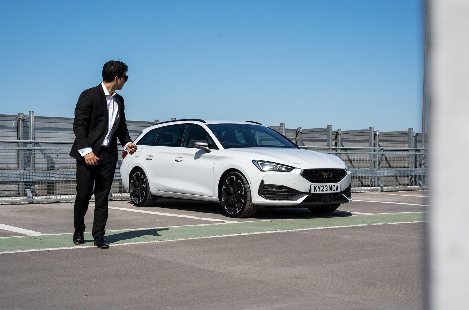 Man walking away from CUPRA Leon Estate in car park