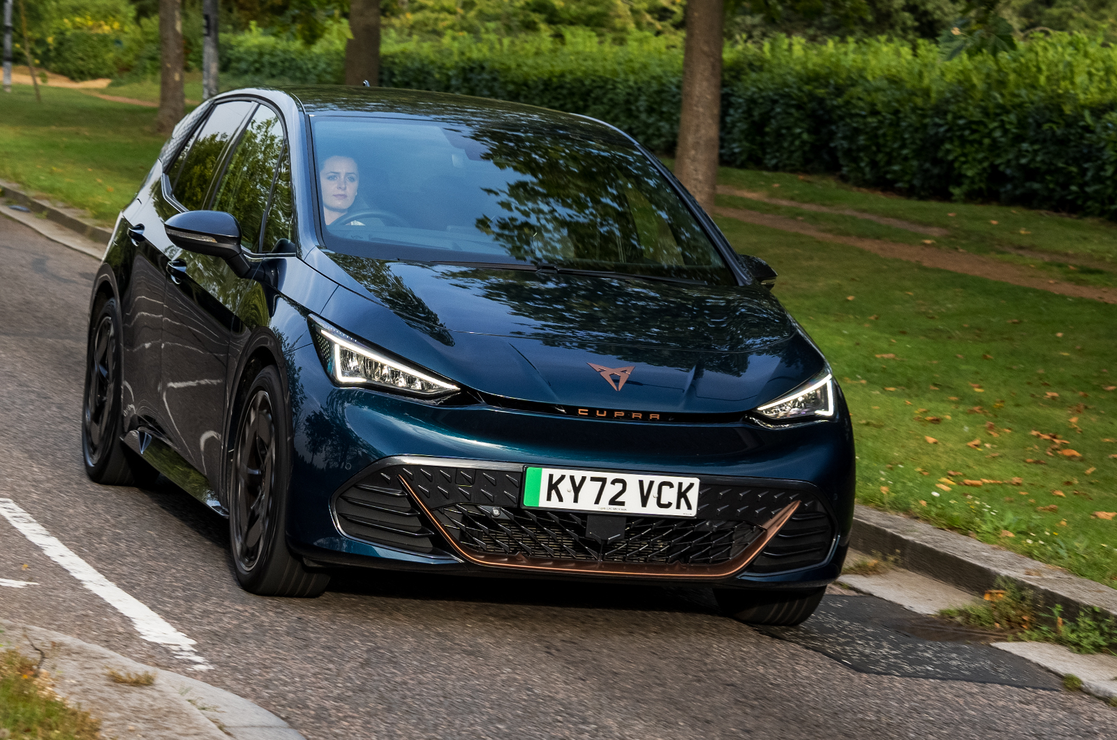 CUPRA Born driving on road front three quarters