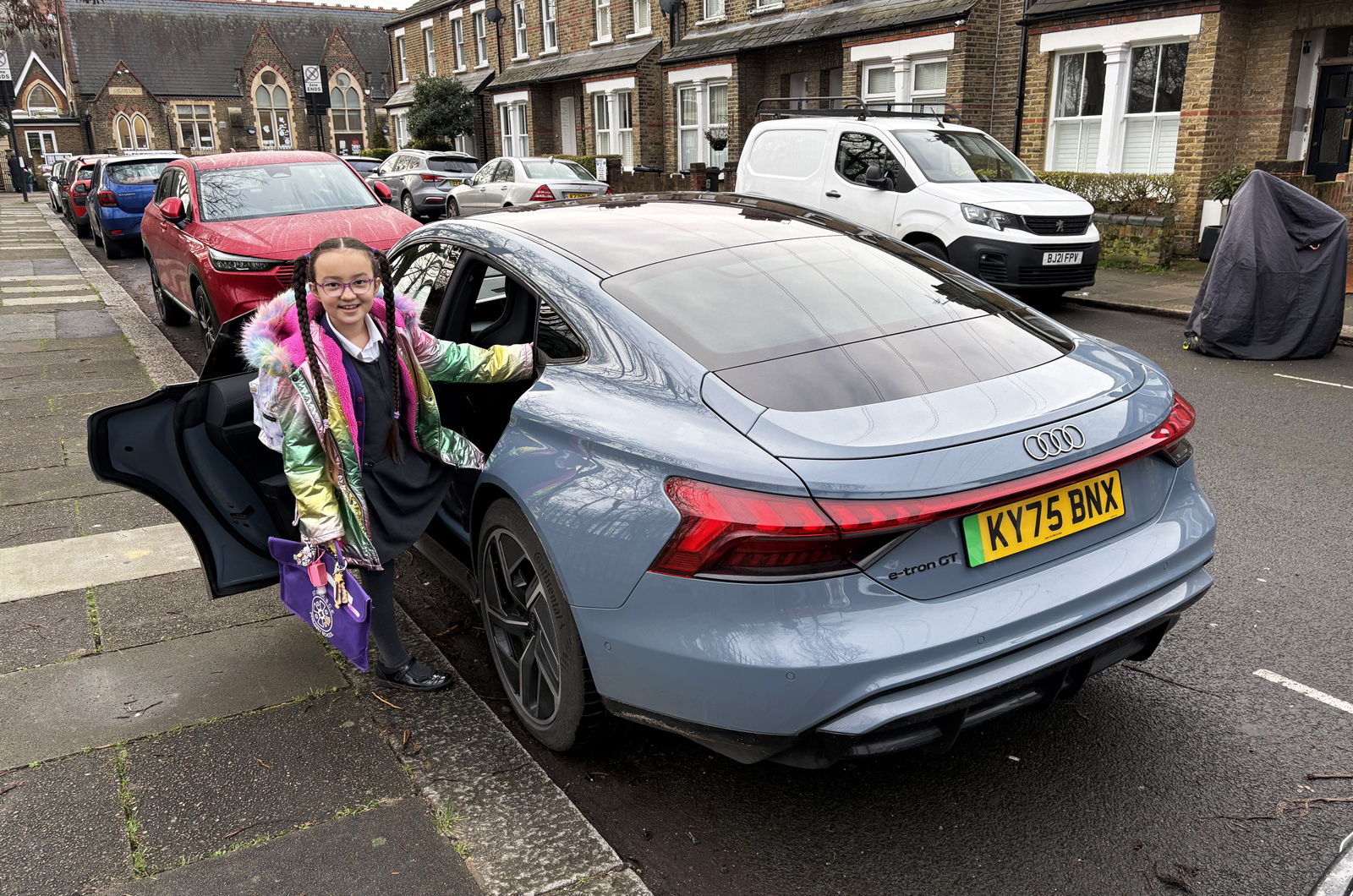 Audi E-tron GT LT with child getting out the back