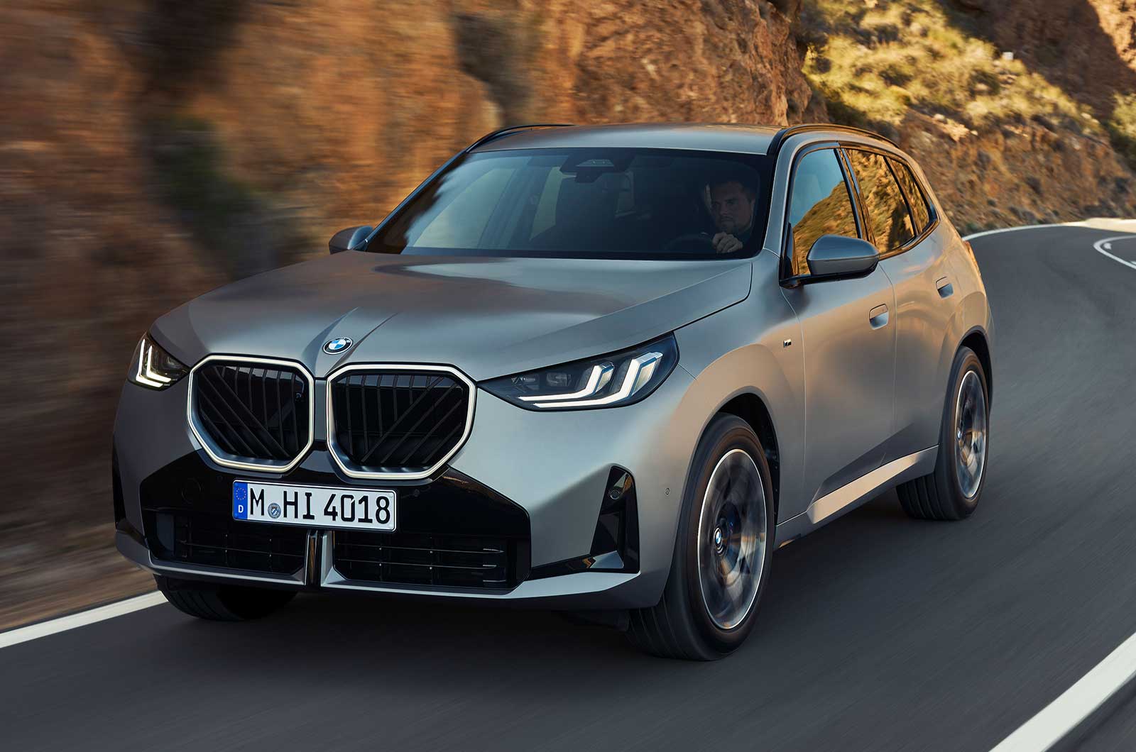 BMW X3 SUV silver front driving