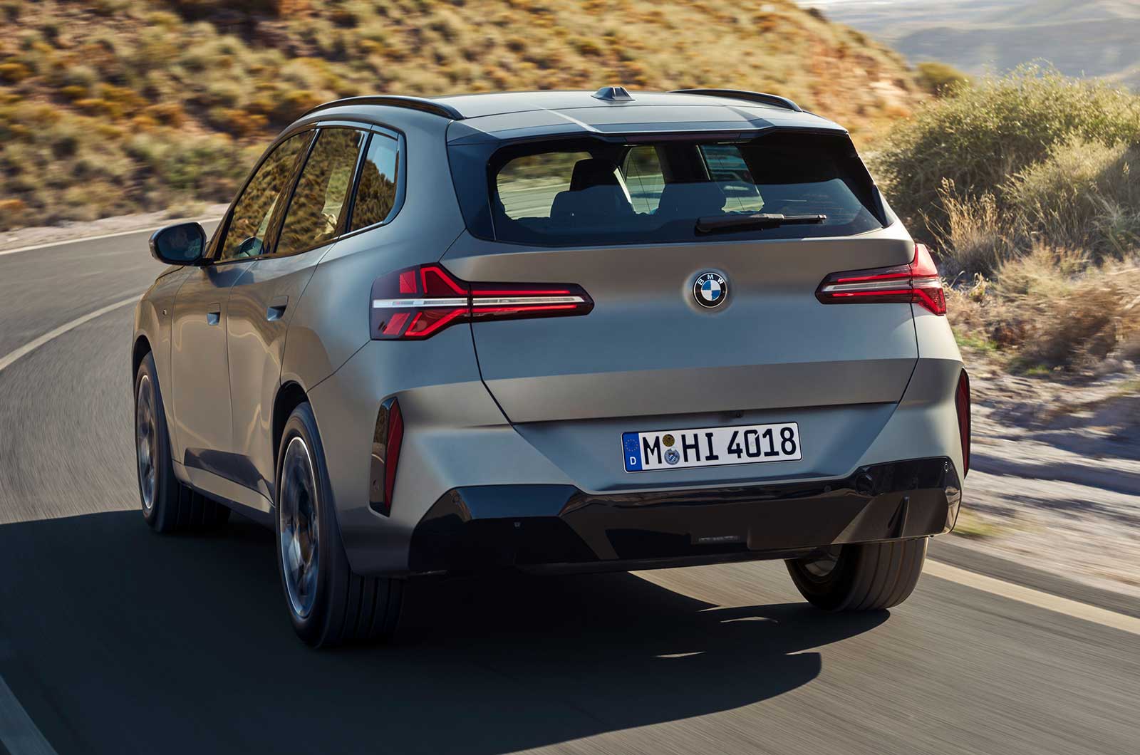 BMW X3 SUV silver rear driving