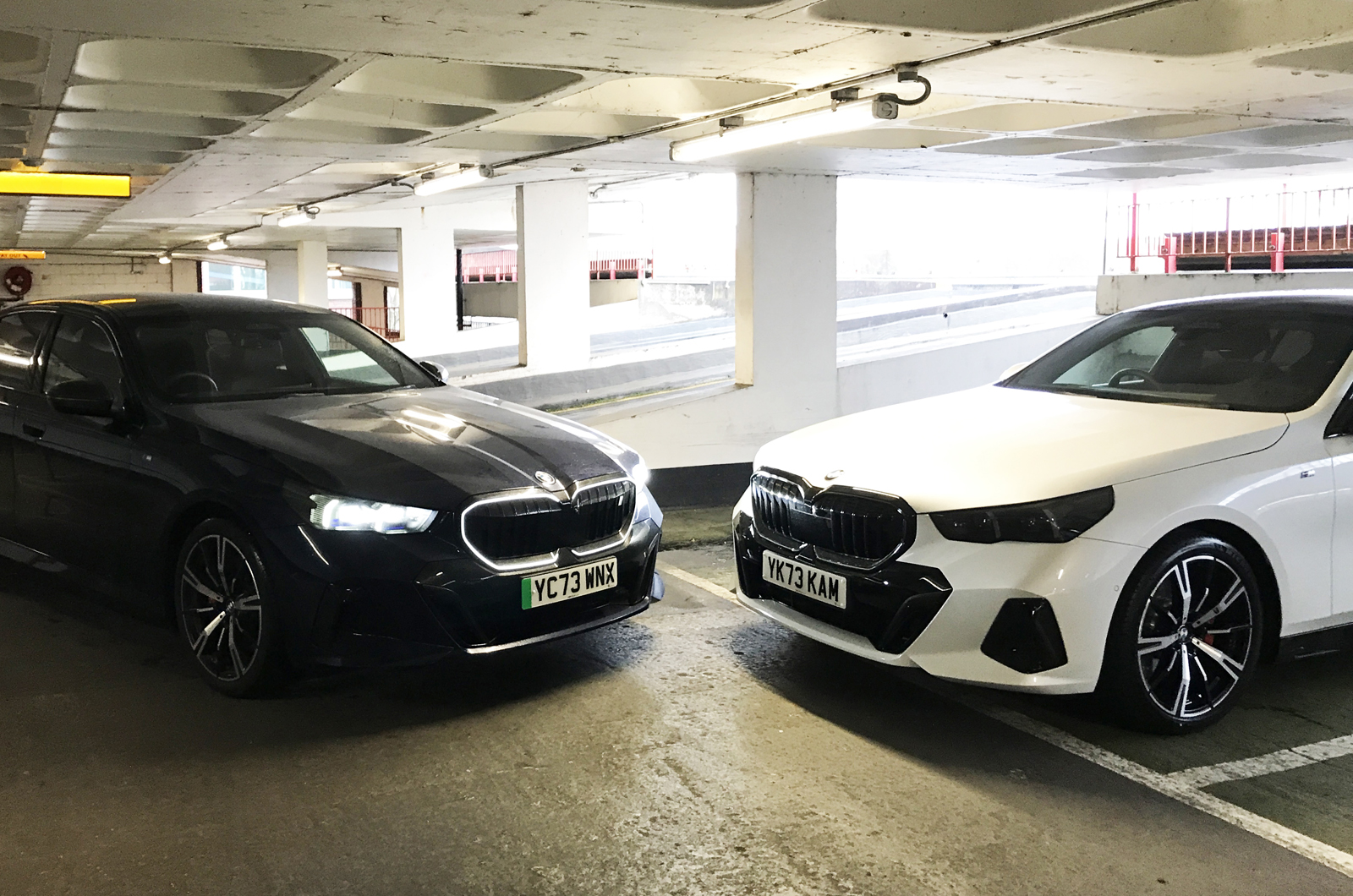 BMW i5 LT with BMW 520i in car park