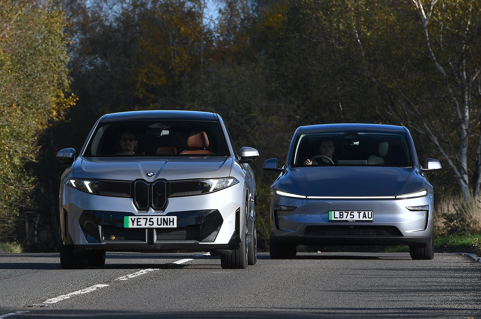 BMW iX3 and Tesla Model Y twin front driving