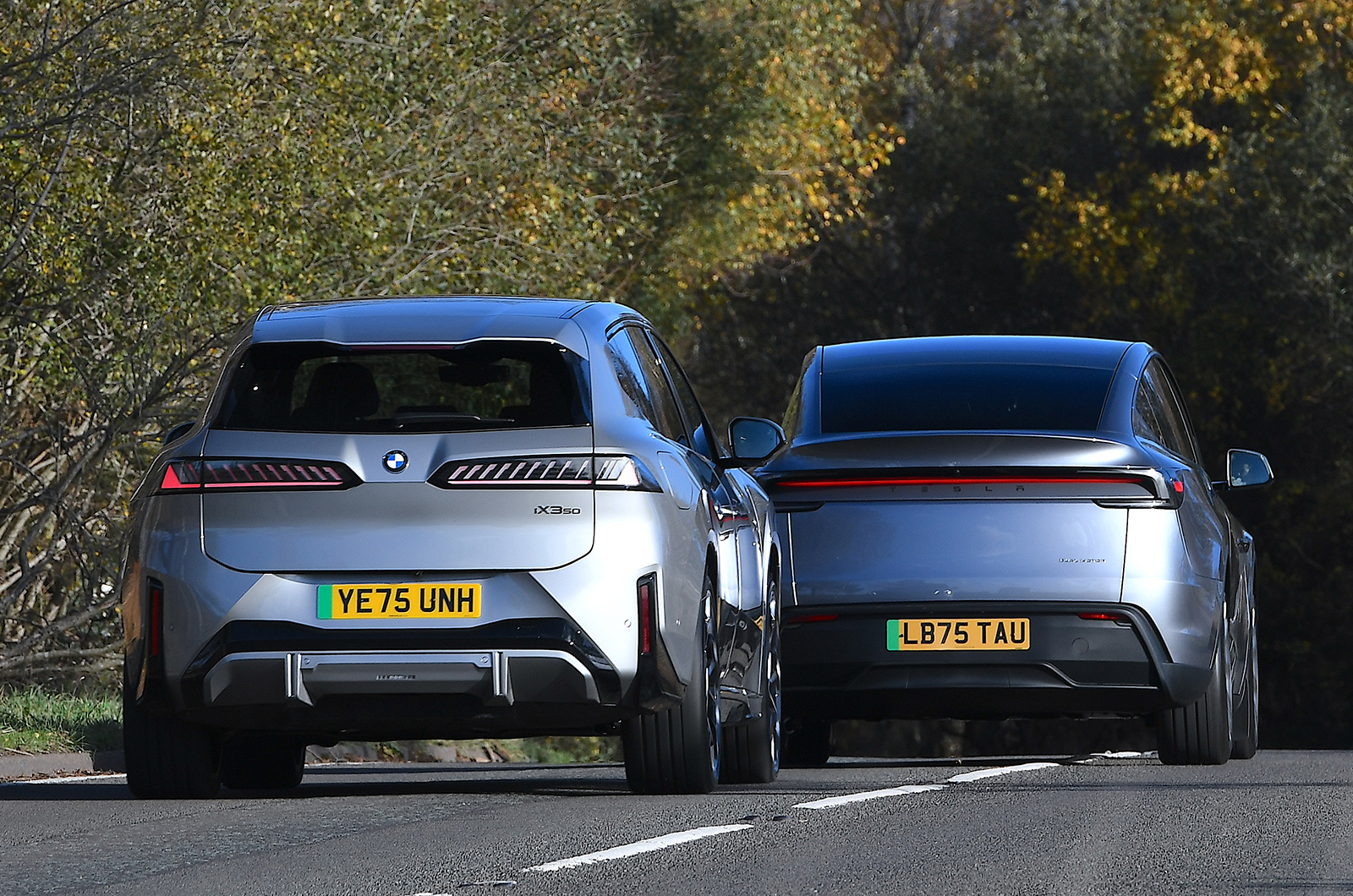 BMW iX3 and Tesla Model Y twin rear driving