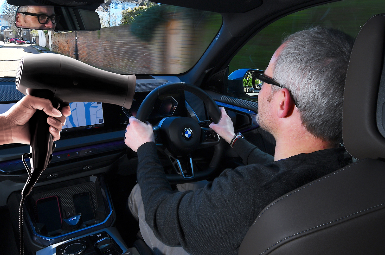 BMW X3 LT from behind the wheel with hair dryer