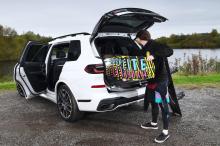 bmw_x7_with_surf_board_being_loaded_into_boot