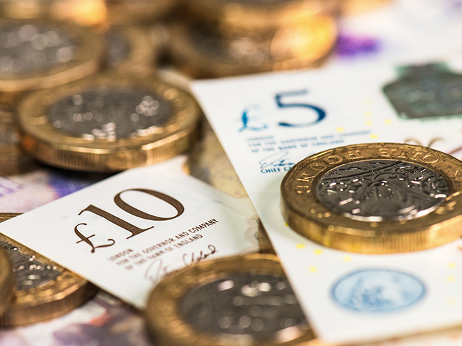 Close up of a large pile of coins and banknotes