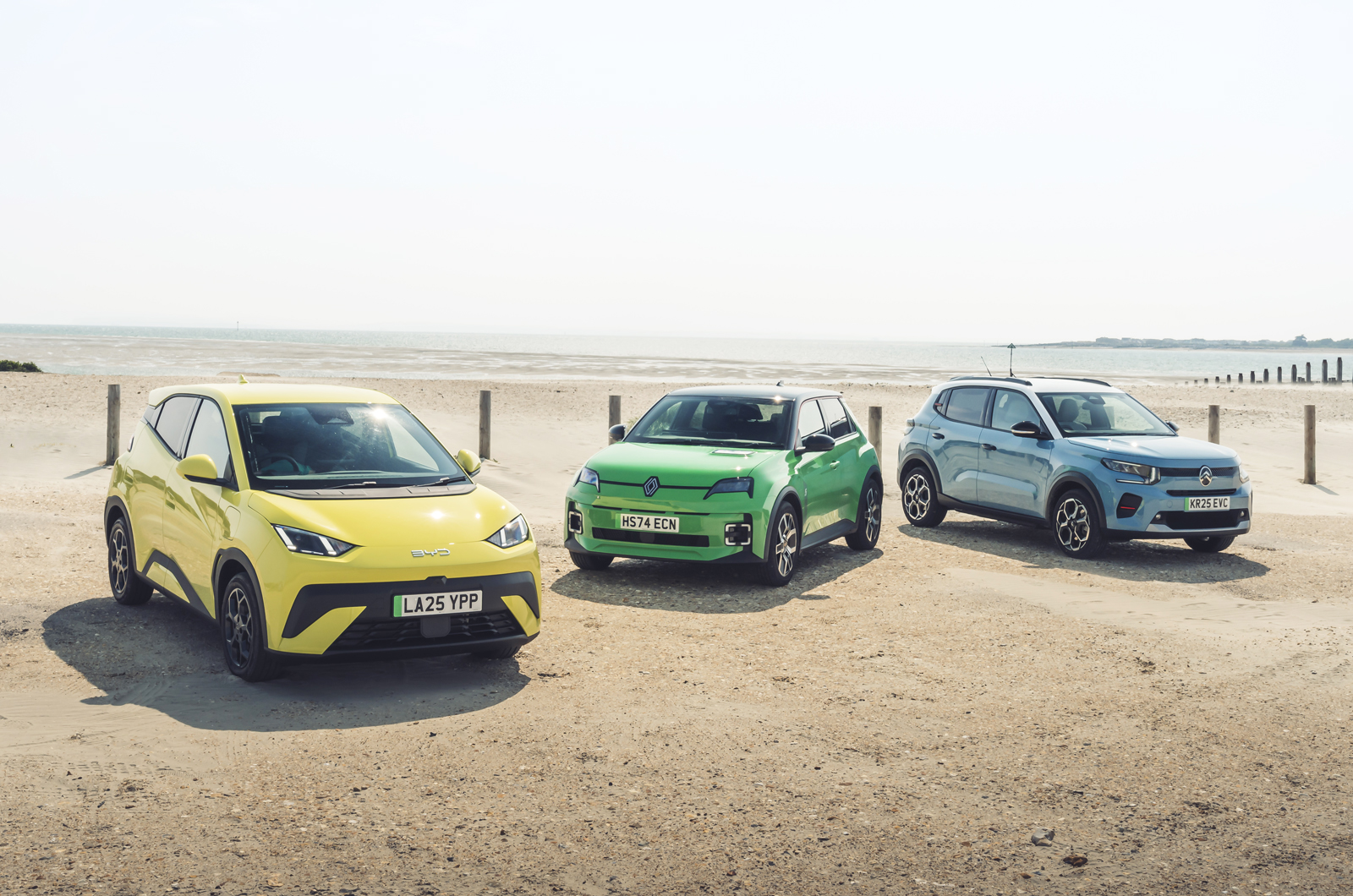 BYD Dolphin Surf vs Citroen e-C3 vs Renault 5 fronts on beach