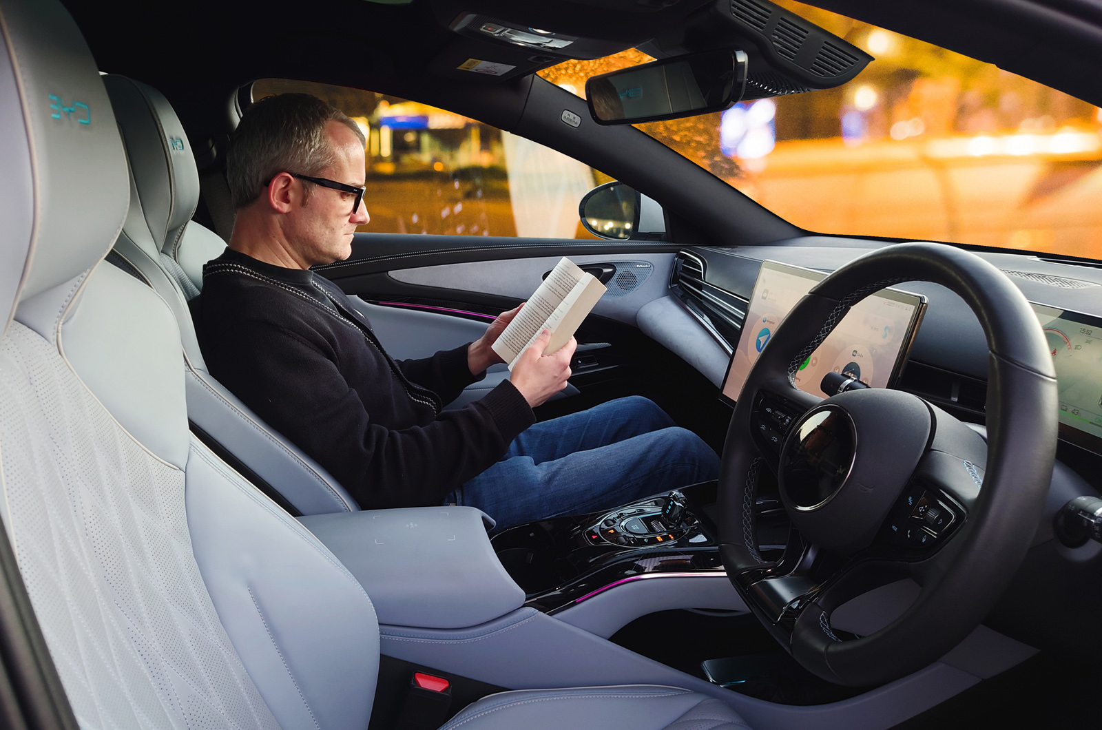 BYD Seal LT with person in passenger seat reading book