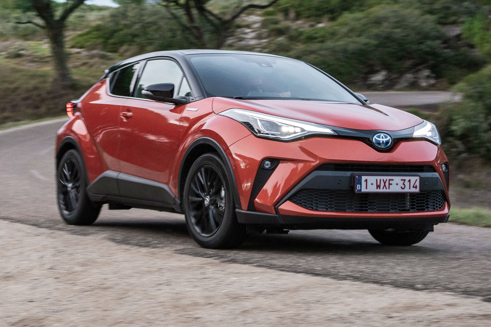 2020 toyota c-hr orange driving front cornering