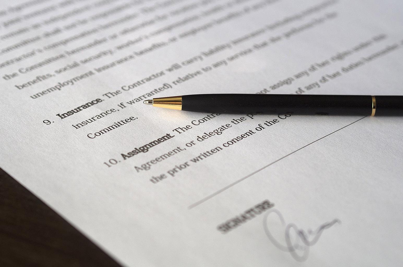 Close up of a pen on car insurance form