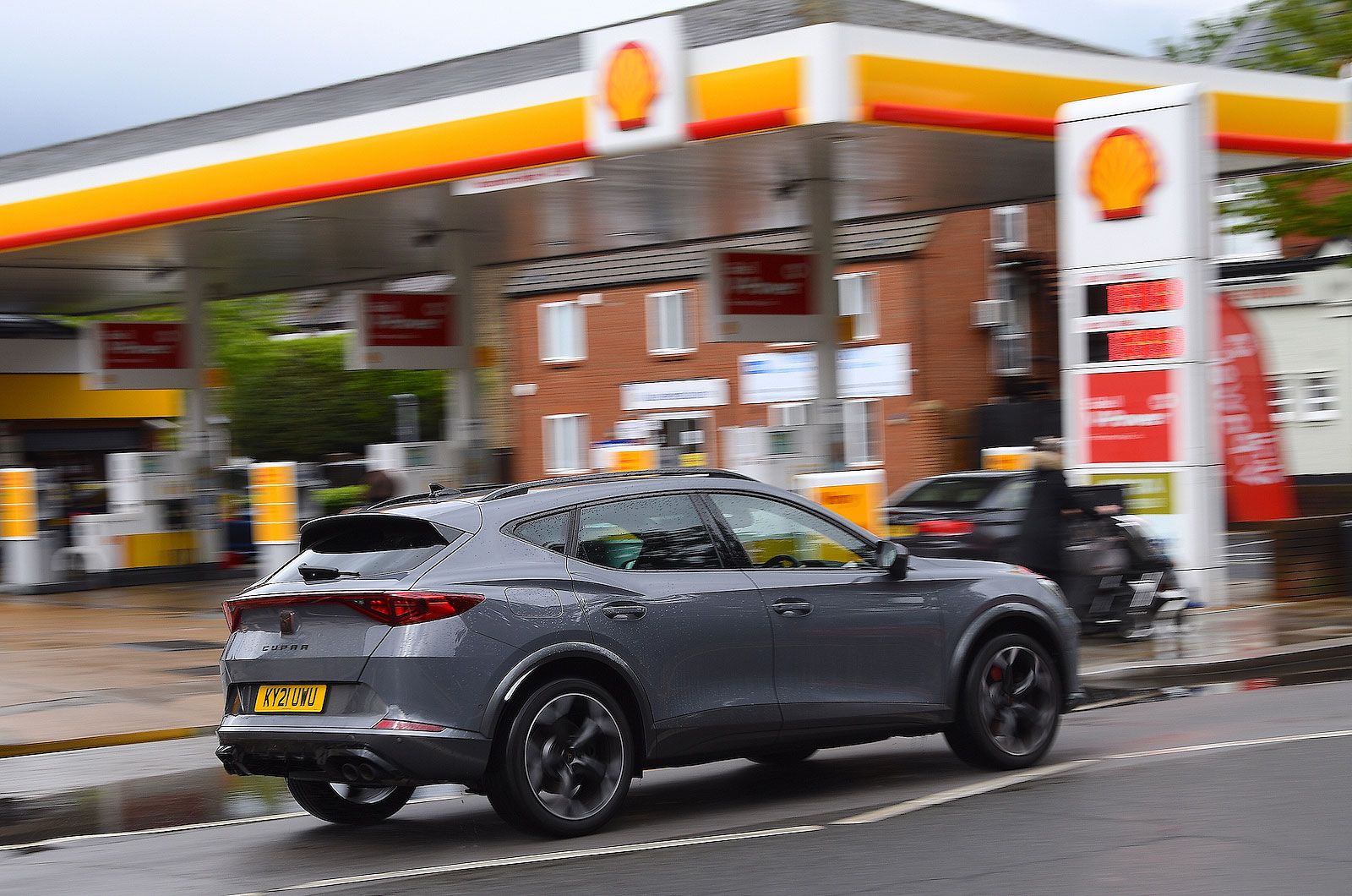 Grey Cupra Formentor driving past a Shell petrol station