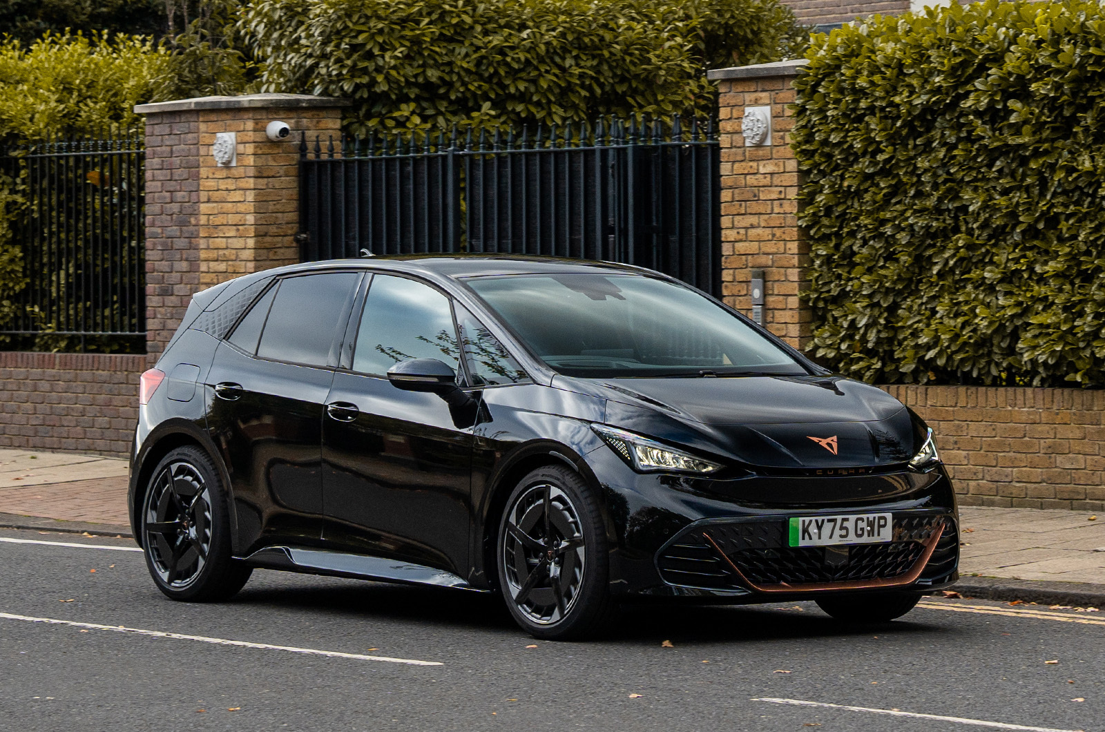 Front three-quarter driving shot of a black CUPRA Born