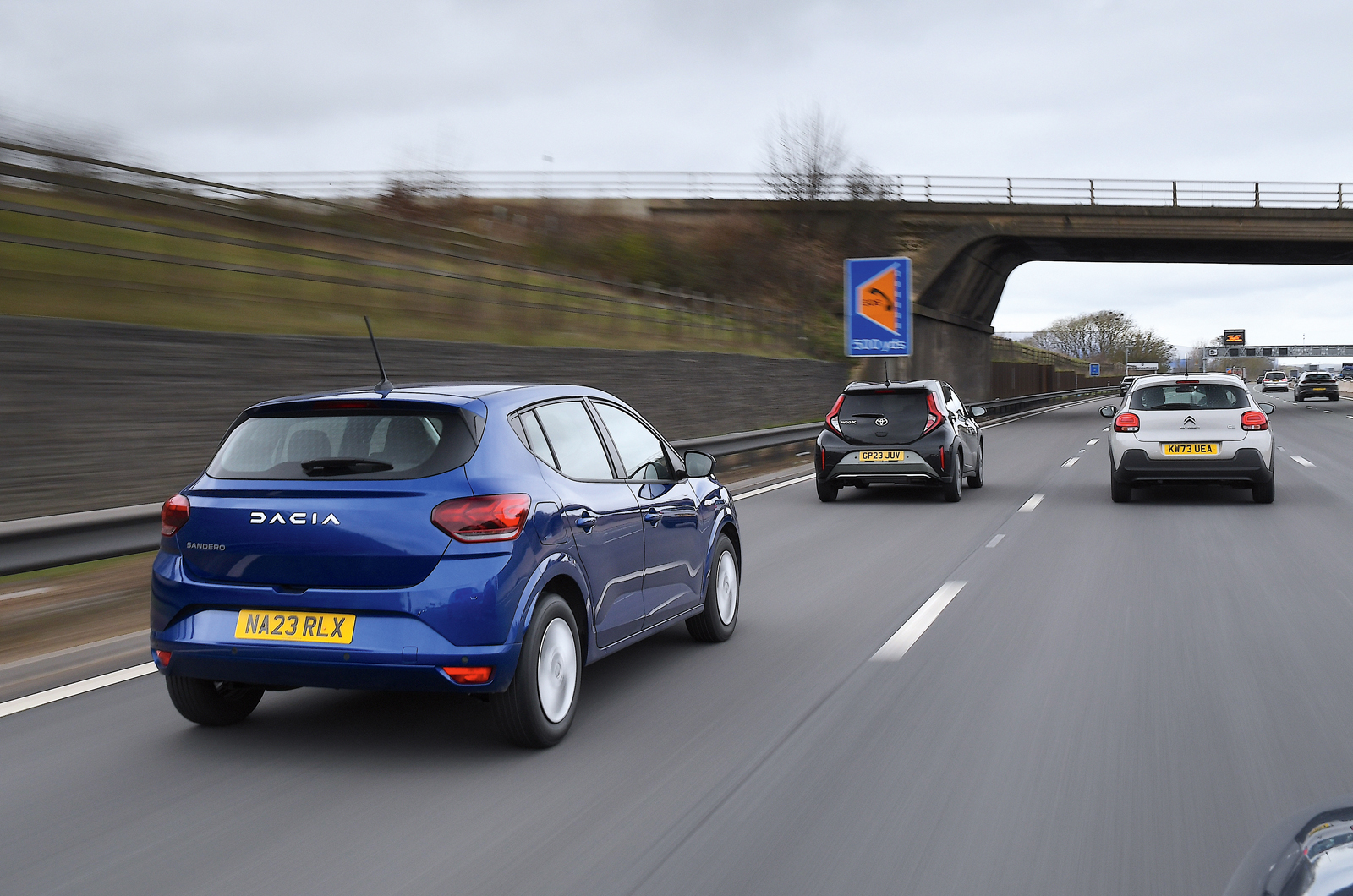 Dacia Sandero with Toyota Aygo X and Citroen C3 on motorway - rears