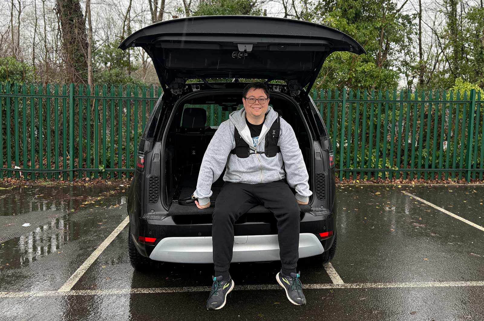 Darren sitting on Land Rover Discovery tailgate