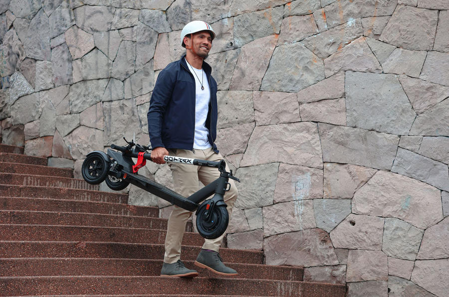 E-scooter with person carrying it
