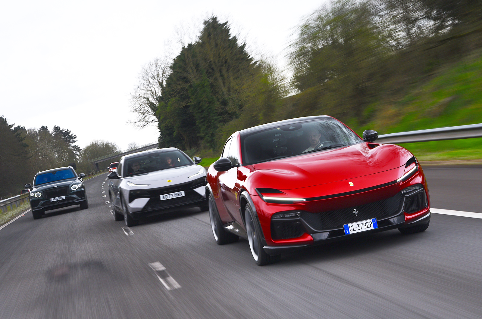 Ferrari Purosangue leading Lotus Eletre and Bentley Bentayga over Severn Bridge
