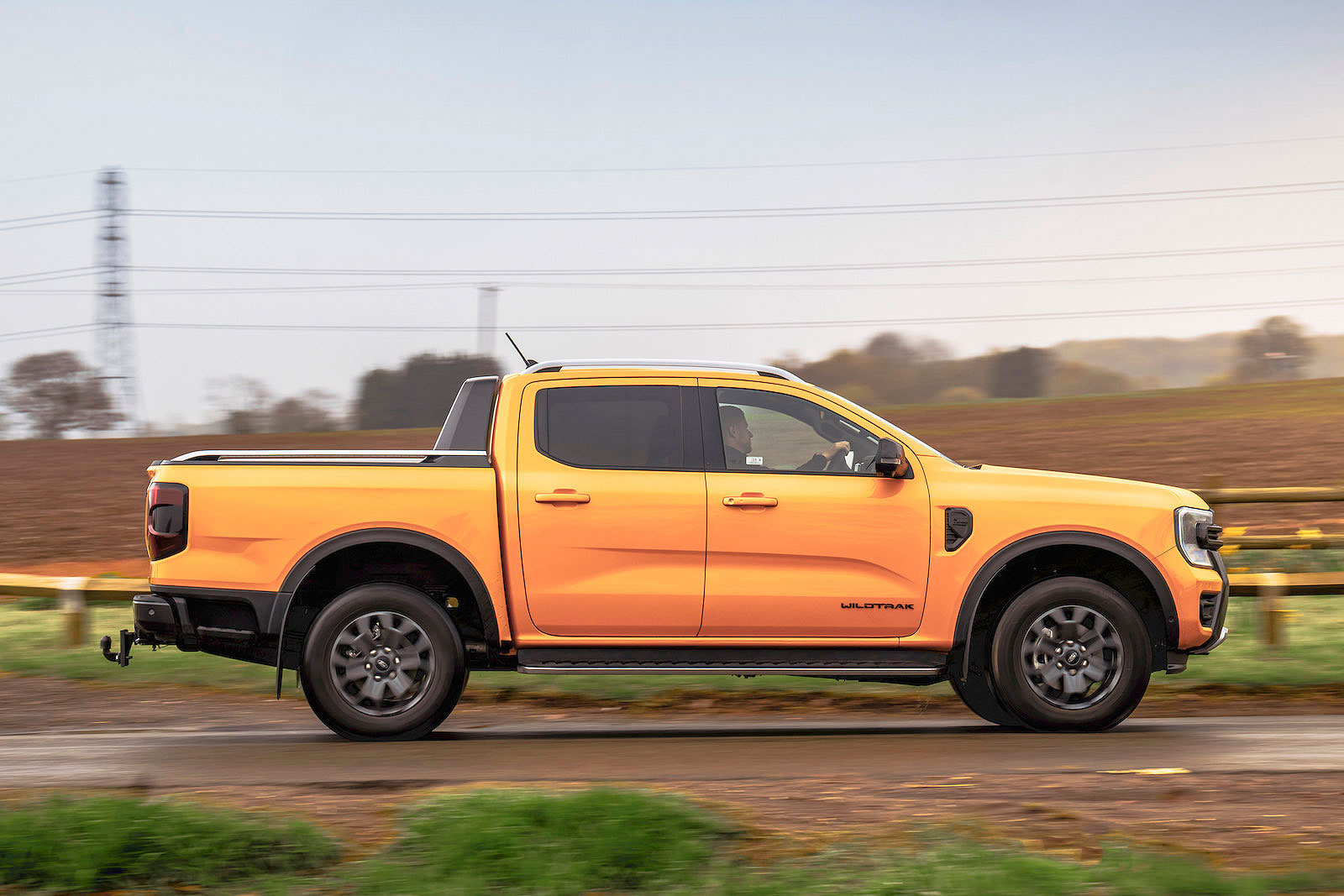 Orange Ford Ranger right driving