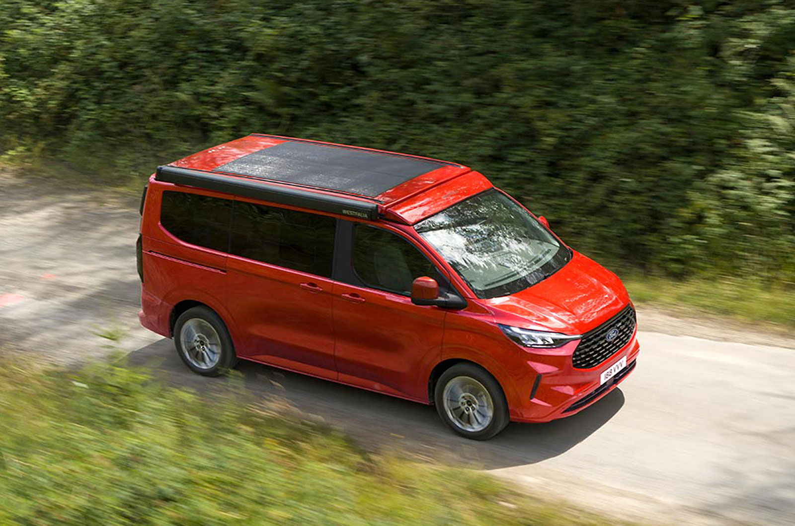 Red Ford Transit Custom Nugget with solar panels