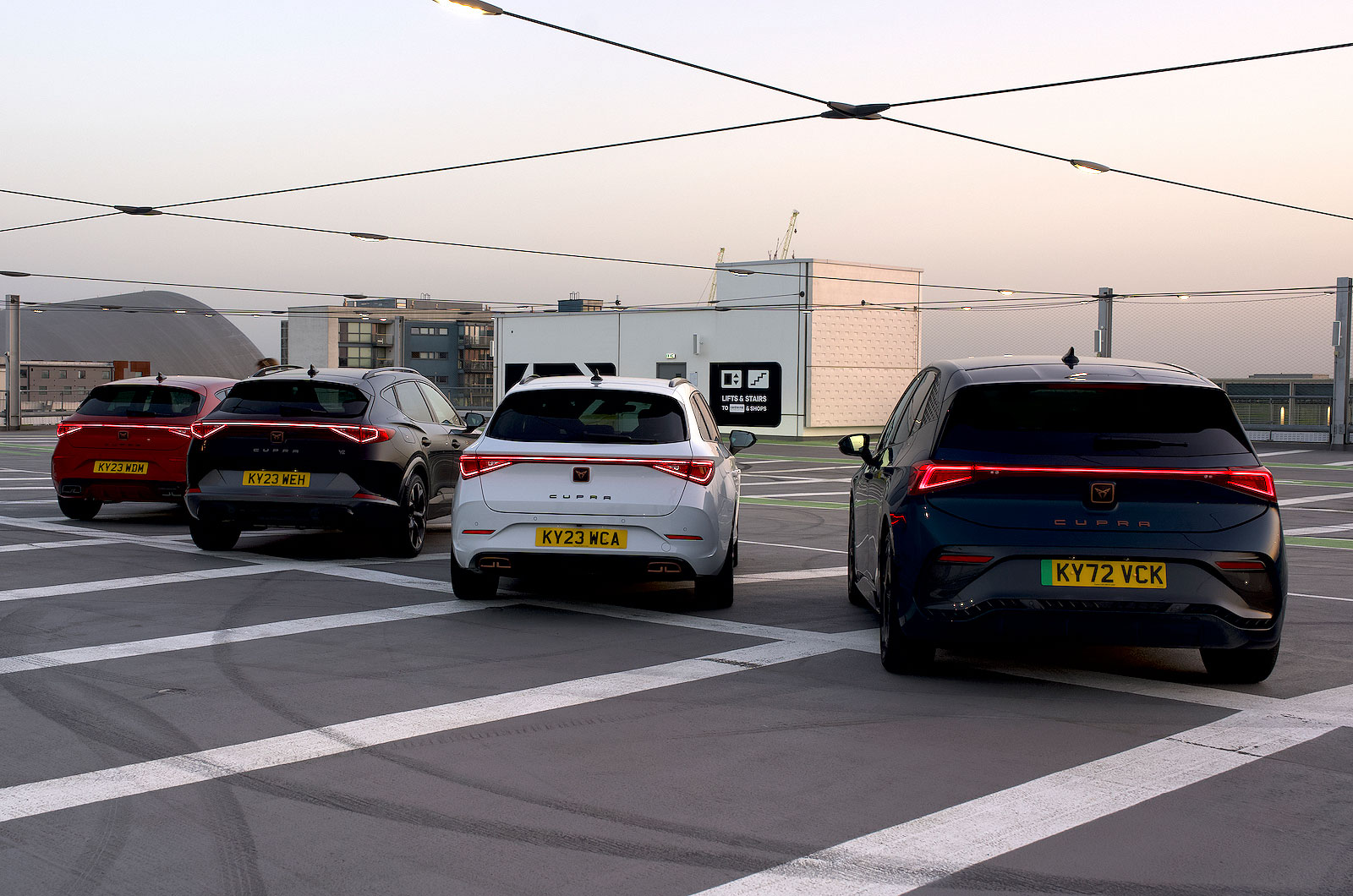 Four Cupra cars in a car park