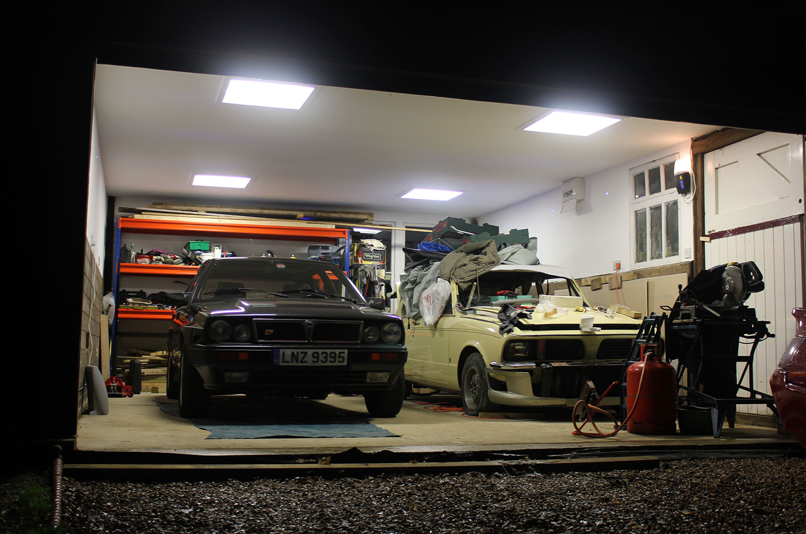 Two cars sitting in a garage