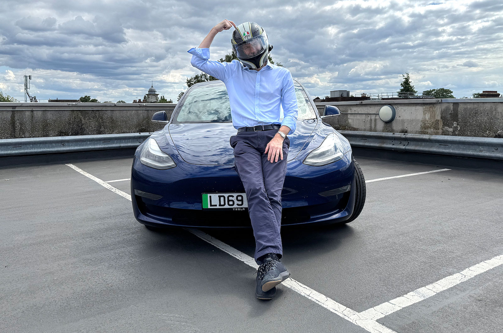 James Tute with crash helmet and Tesla Model 3 Performance