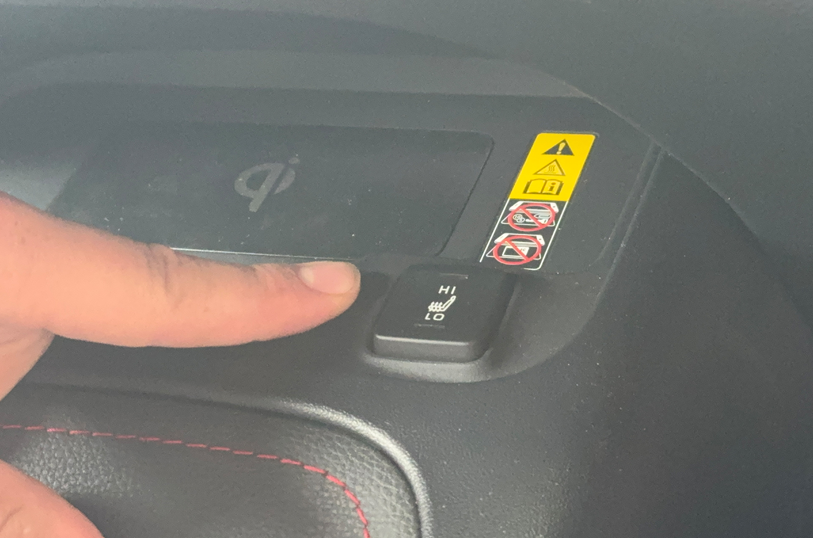 Jonty pointing at Toyota Corolla Touring Sports heated seat button