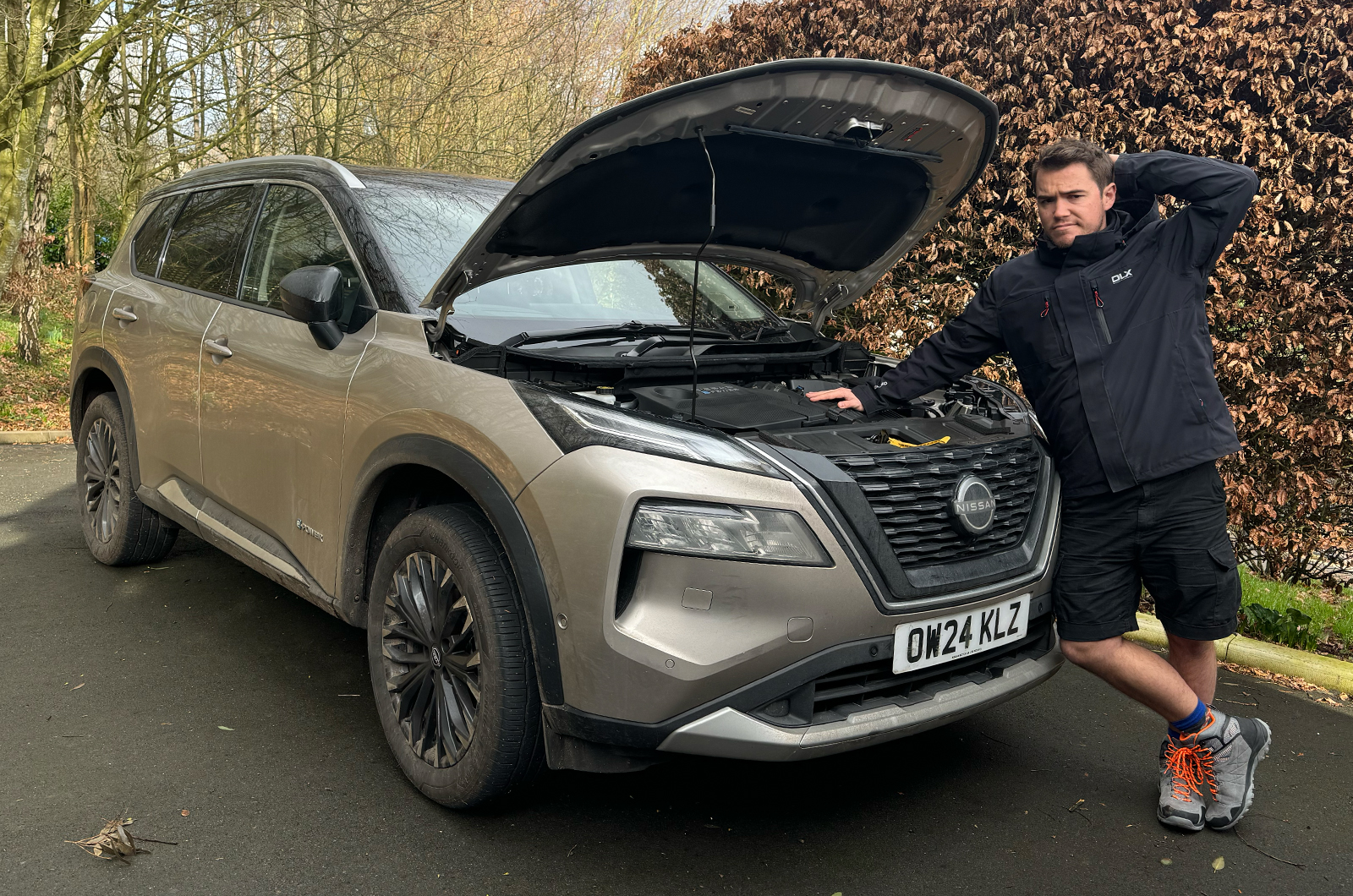 Jonty Renk looking inquisitive in front of long-term X-Trail with bonnet up