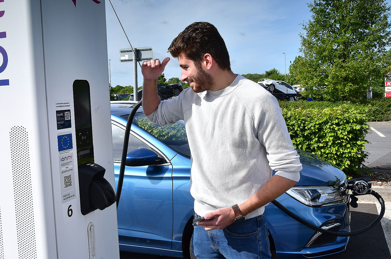 Kiall Garrett using an electric car charger
