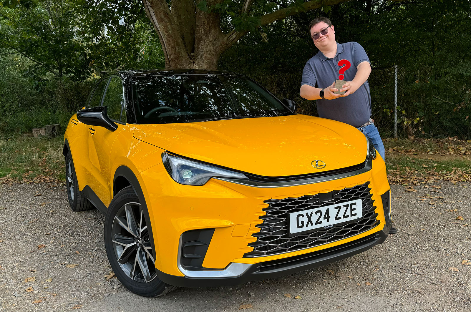 Lexus LBX SUV yellow with Darren Moss and What Car? trophy
