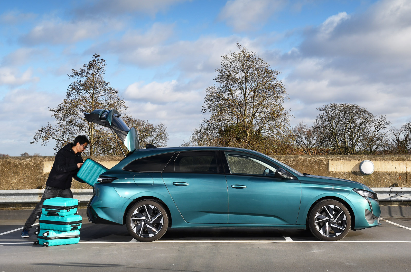 Loading suitcases into boot of Peugeot 308 SW