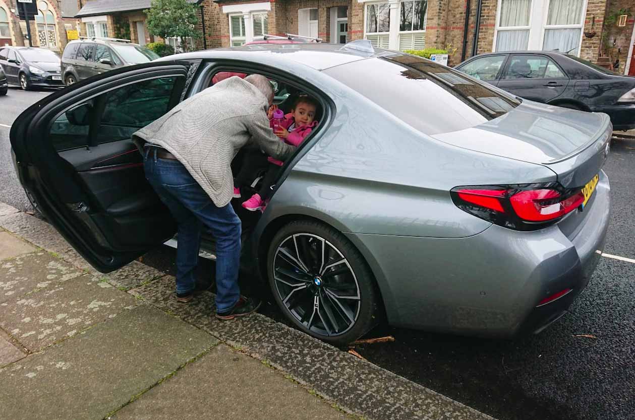 LT BMW 530e - child being lifted out of rear seat