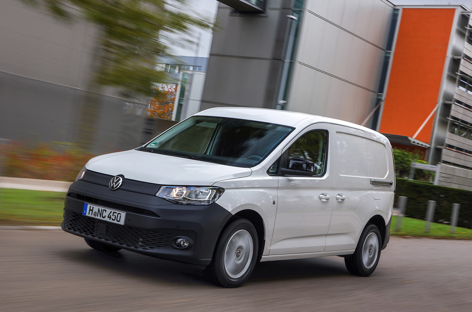 White Volkswagen Caddy Cargo on the road viewed fro front three quarter
