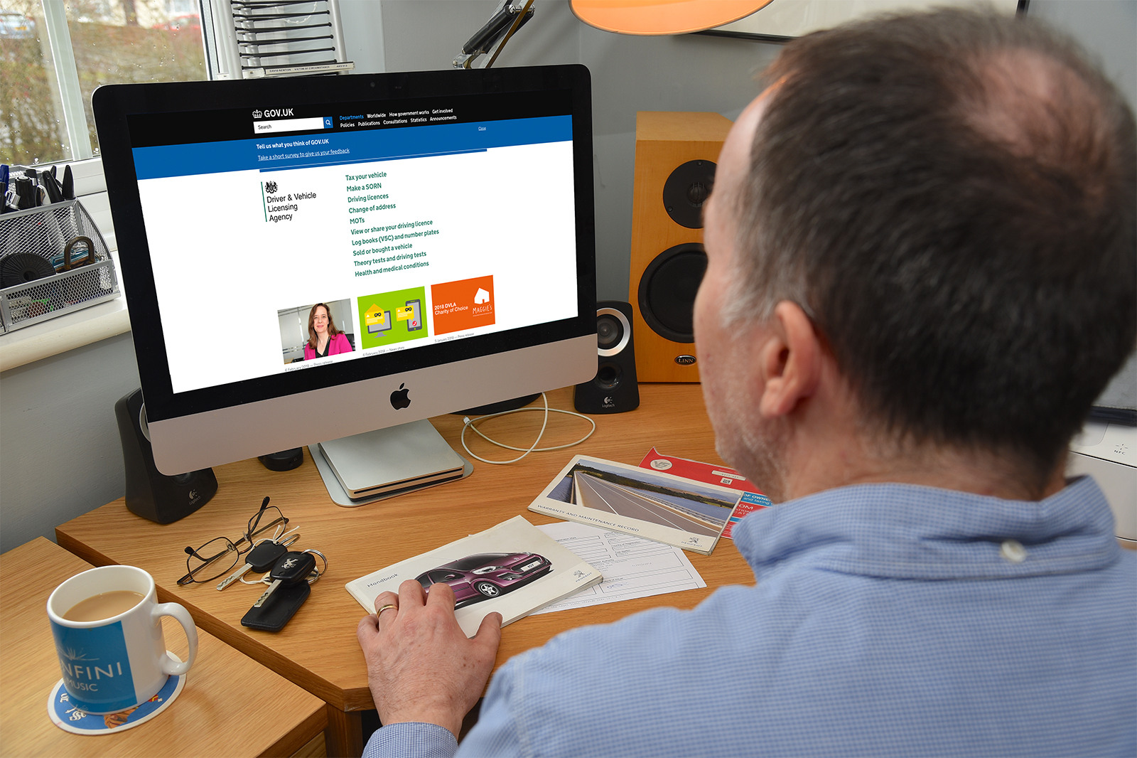 Man looking at laptop screen and DVLA website