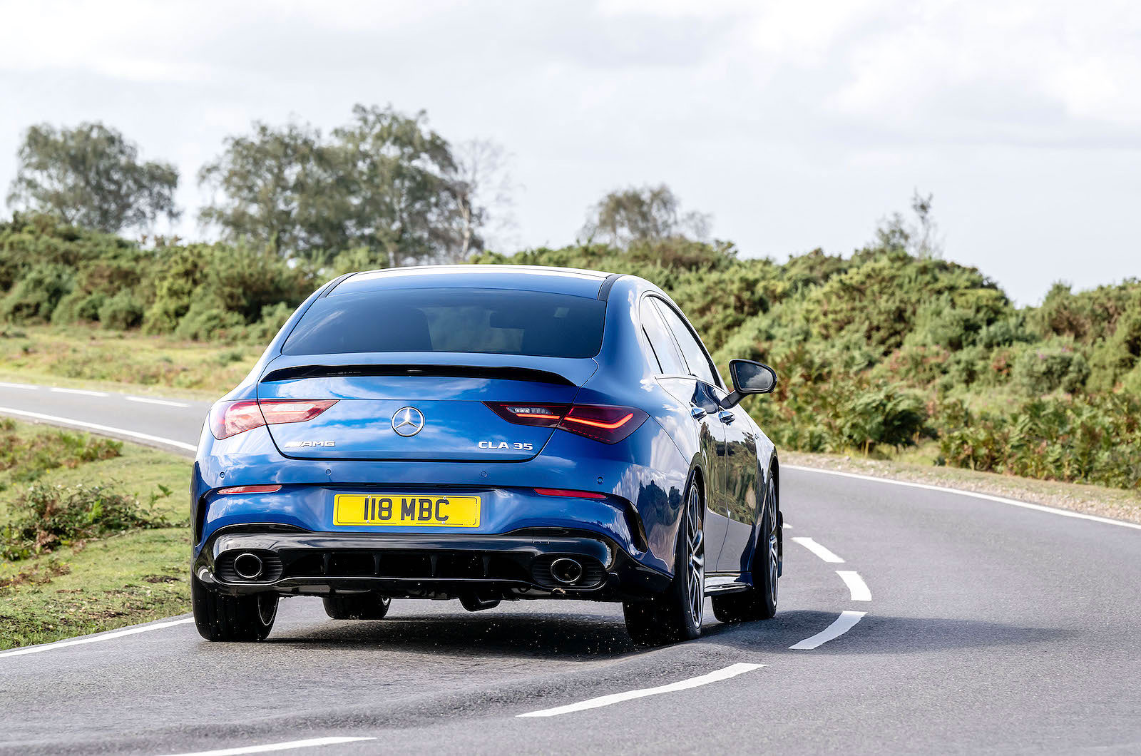 Blue Mercedes-AMG CLA 35 rear cornering