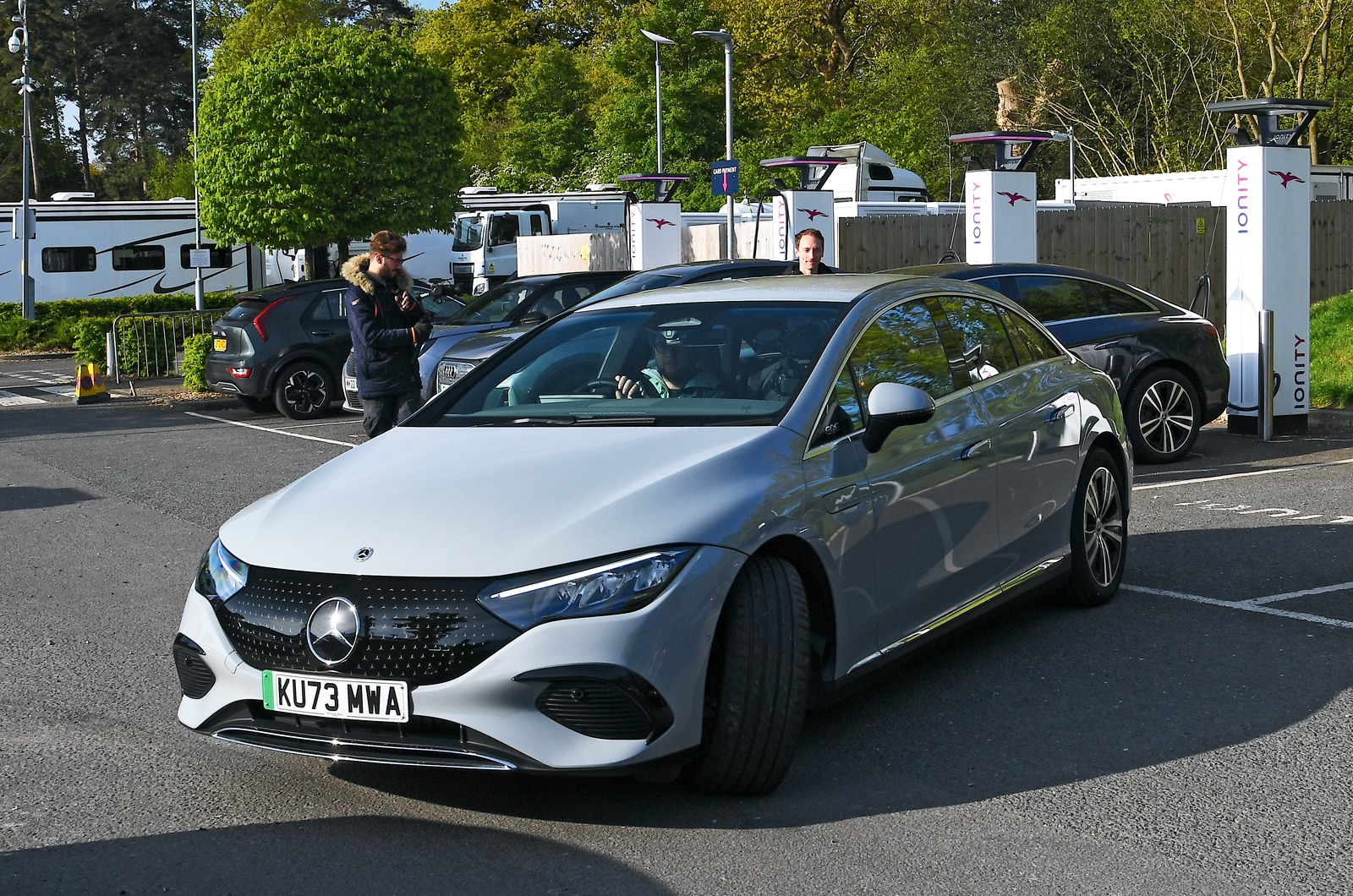 Mercedes EQE leaving motorway charging station