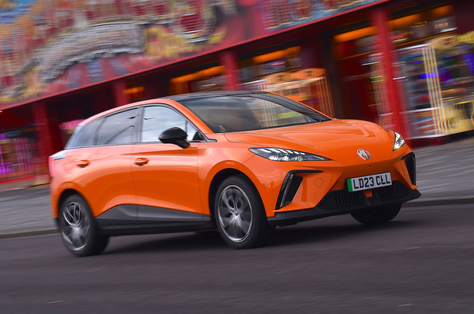 Orange MG4 EV front right driving