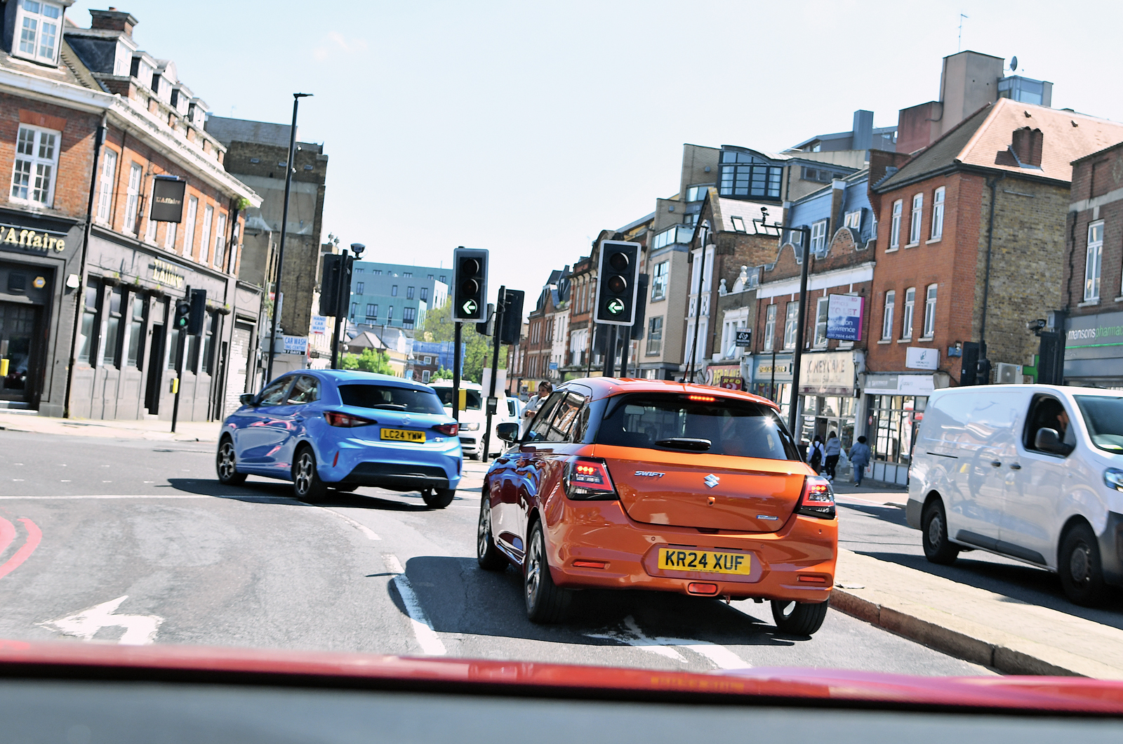 MG 3 and Suzuki Swift rears driving in town