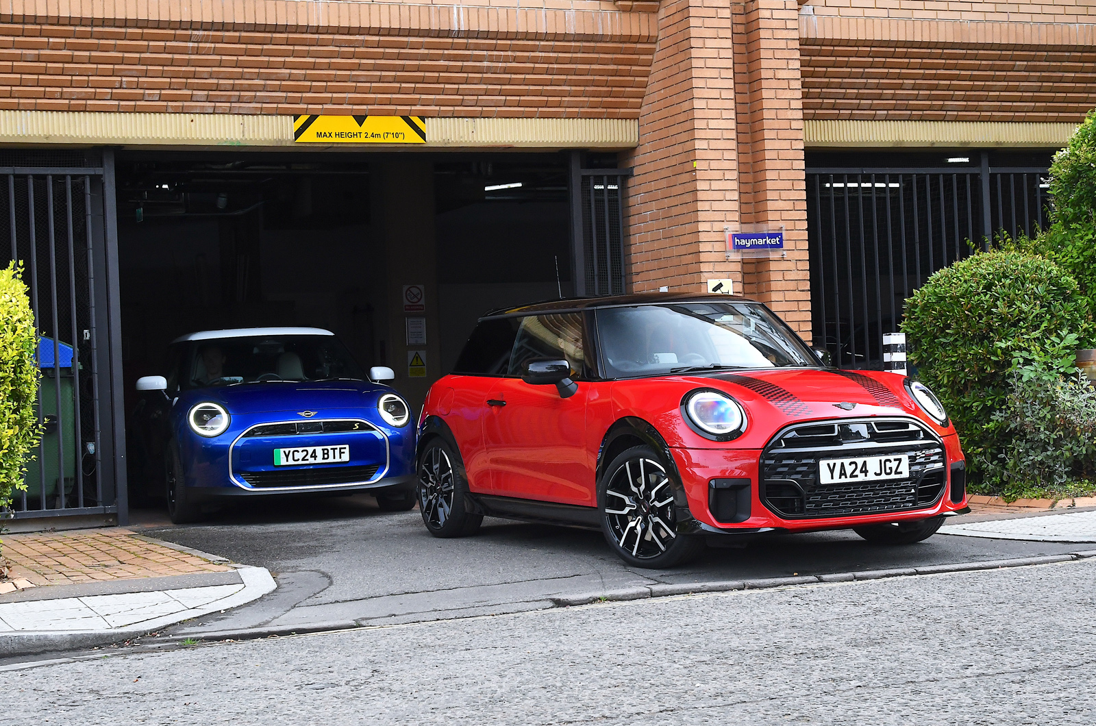 Mini Cooper SE and Mini Cooper S leaving car park