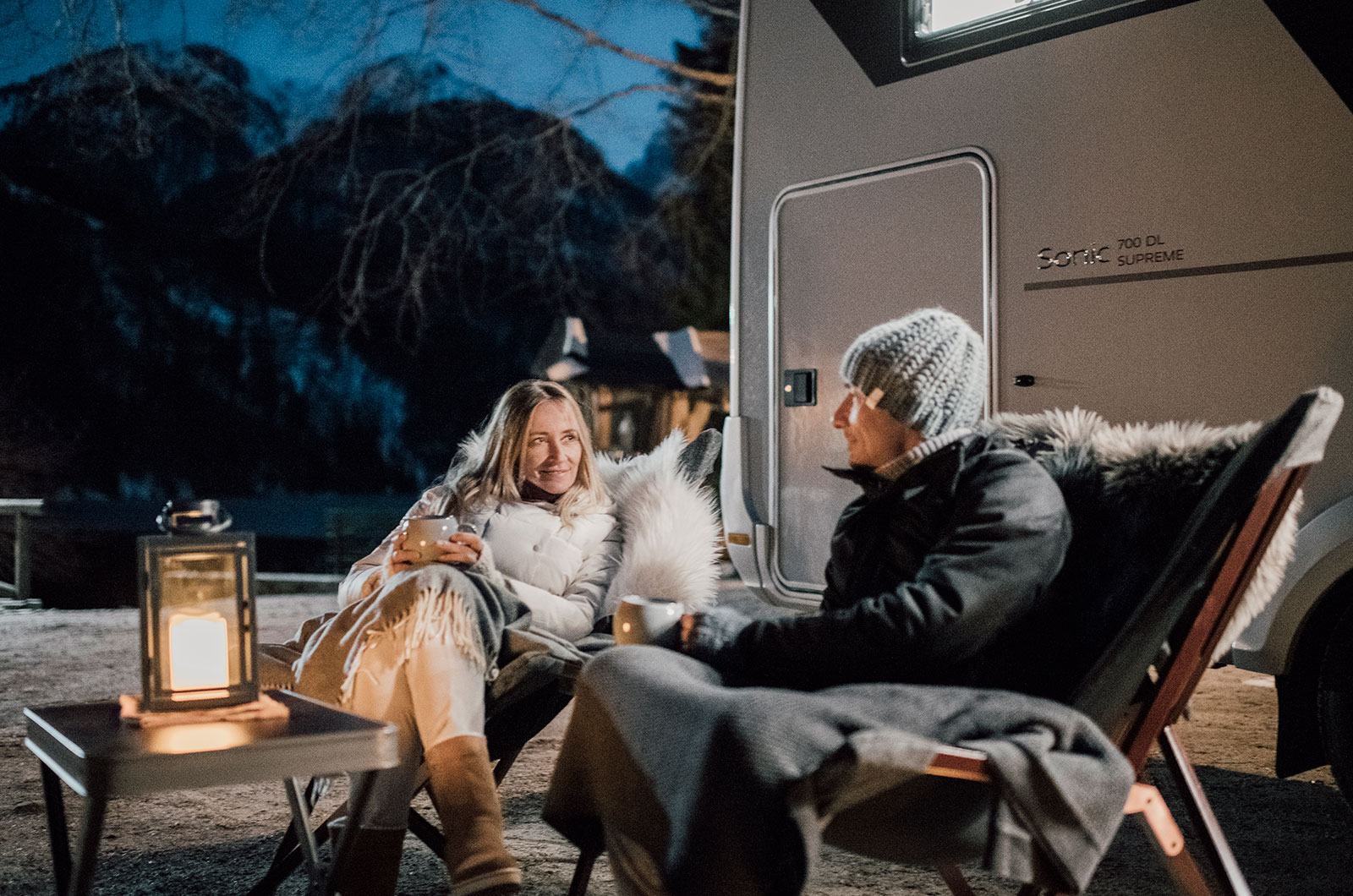 Couple relaxing outside motorhome