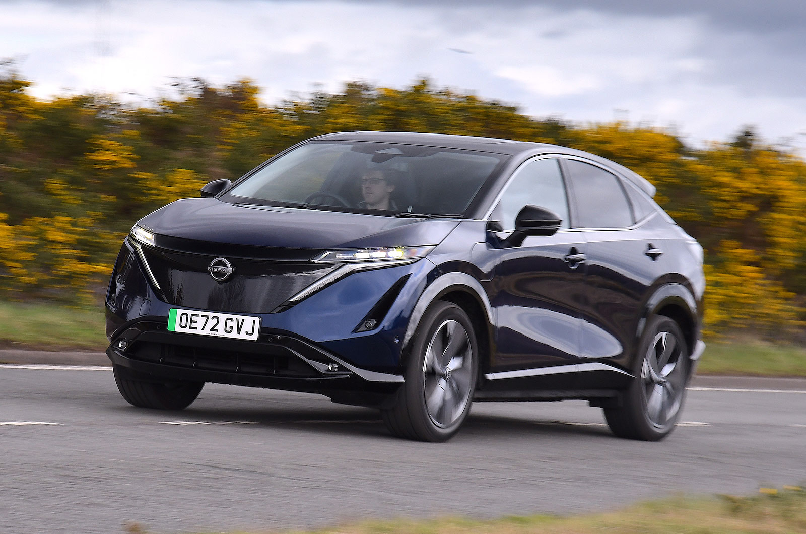 Blue Nissan Ariya front left driving