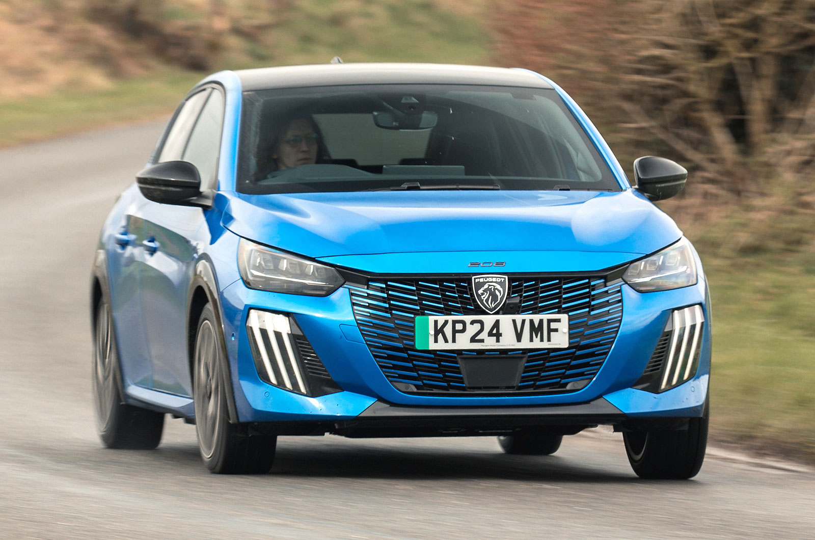 Blue Peugeot e-208 front cornering