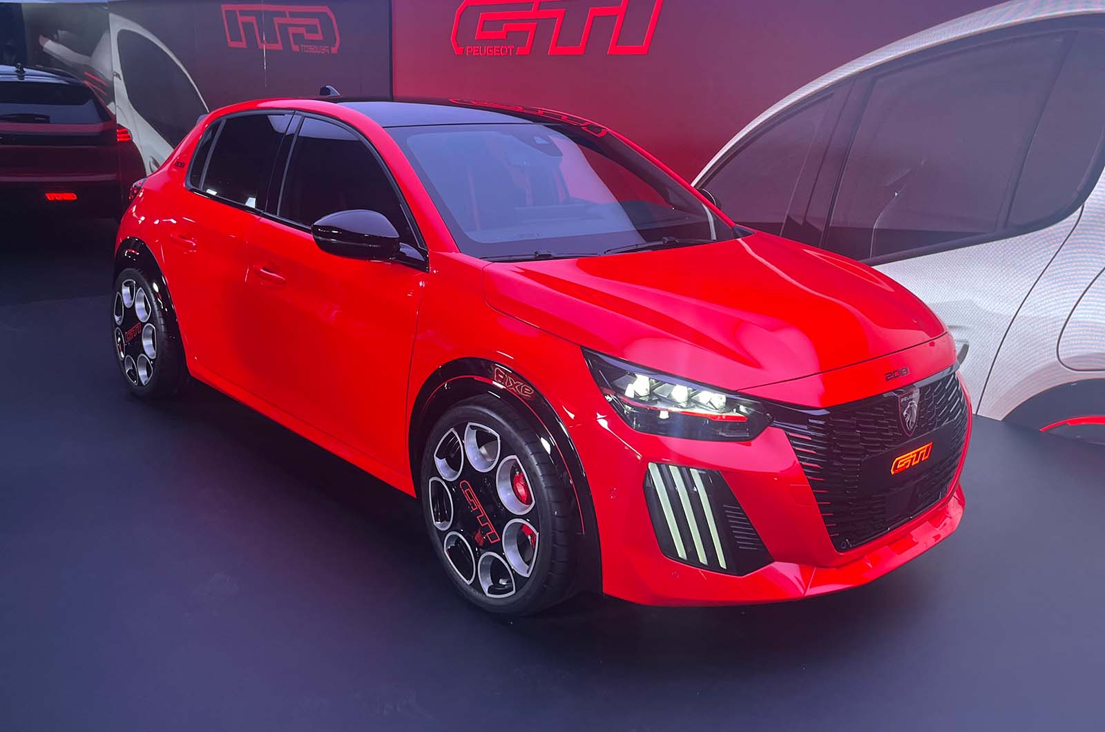 Peugeot e-208 GTI front static red studio