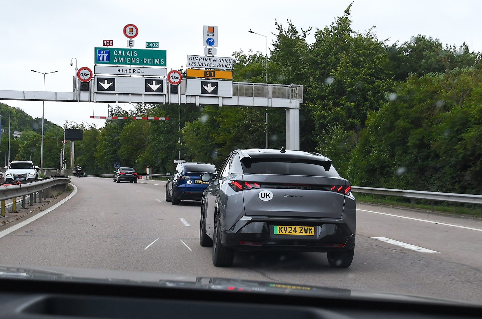 Peugeot e-3008 following Tesla Model Y on autoroute